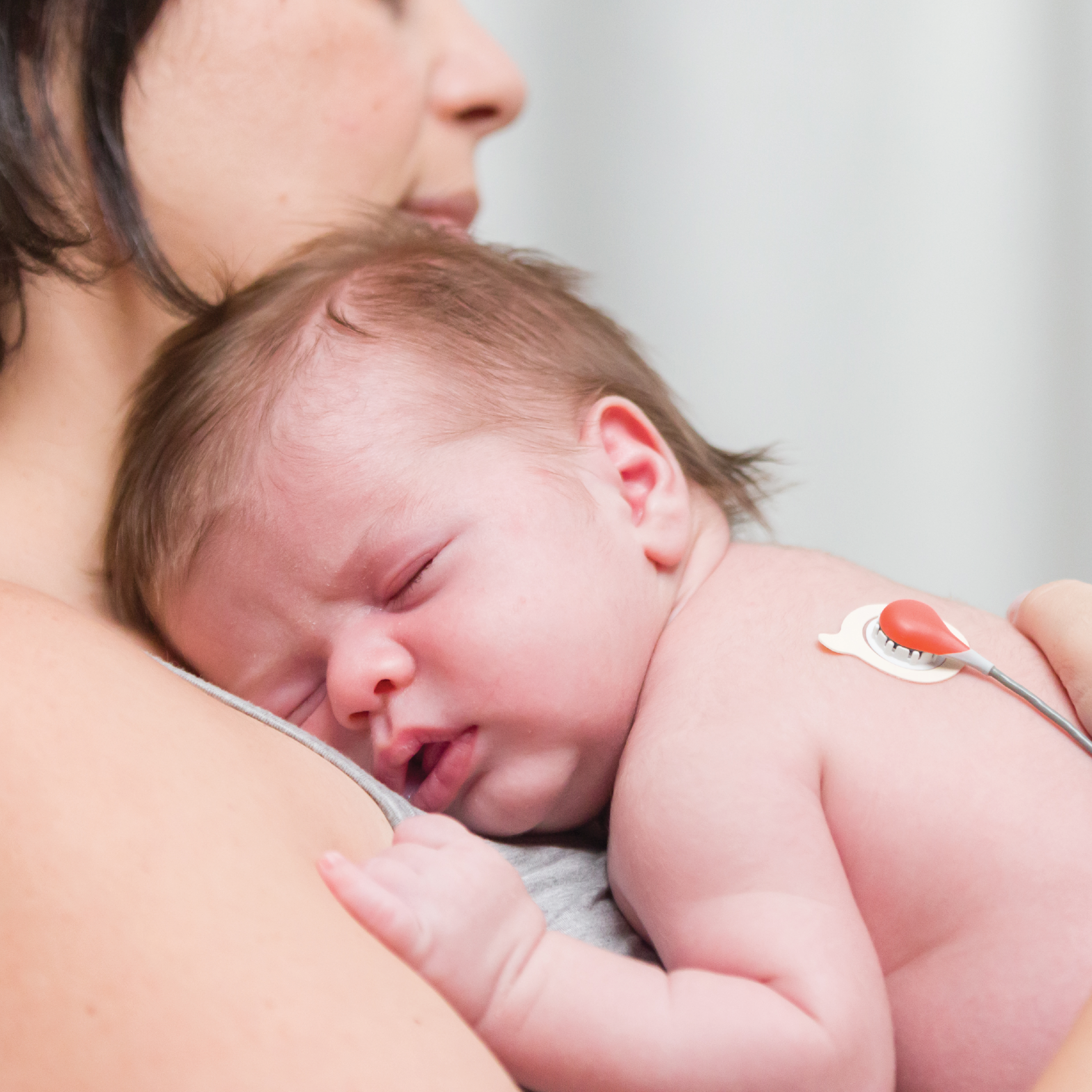 mother using the kangaroo care method with her newborn baby